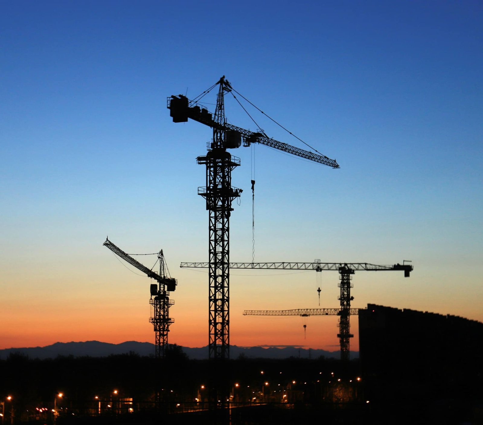 Construction site with tower cranes against an open sky