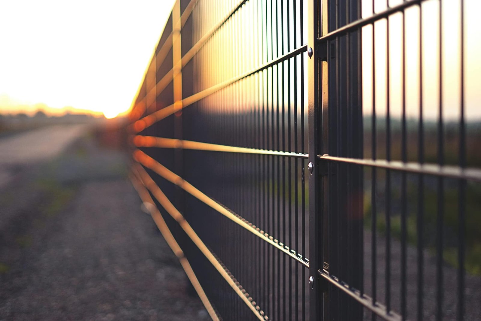 Perimeter palisade fencing along a secured site boundary